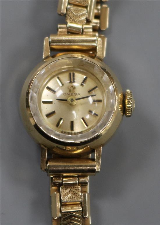 A ladys 9ct gold Omega manual wind wrist watch, on a steel and gold plated bracelet, with Omega box.